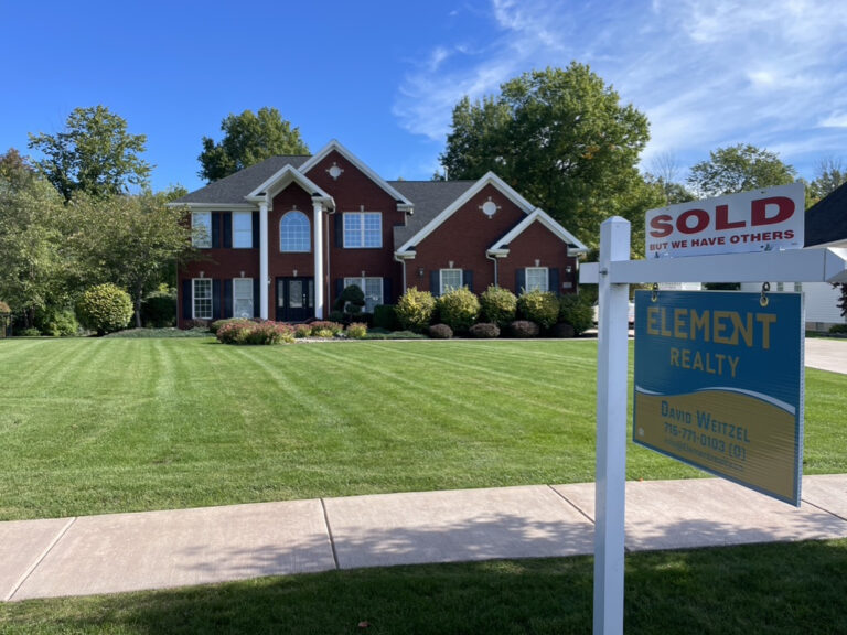 Sold sign in front yard of single family home